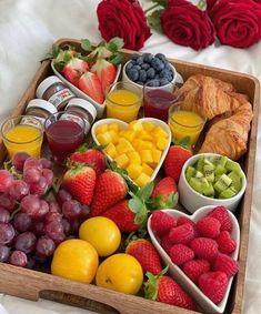 a wooden tray filled with fruit and pastries