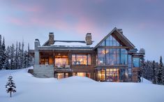 a large house is covered in snow at dusk