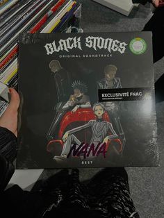 a person holding up a vinyl album