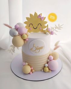 a cake decorated with pastel colors and decorations