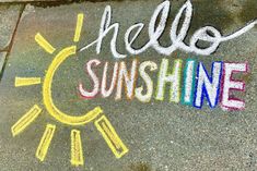 the words hello sunshine written in chalk on asphalt