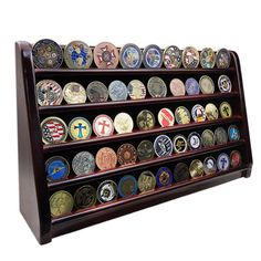 a wooden display case filled with lots of different types of medals on it's sides