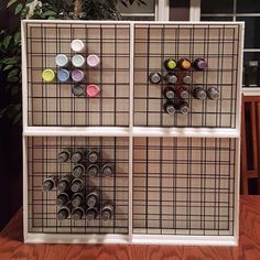 a shelf that has some cans on it and is decorated with magnets in the shape of squares