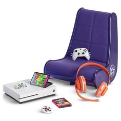 a purple chair with headphones and a game controller next to it on a white surface