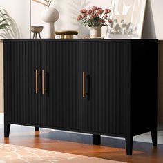 a black cabinet with two doors and some flowers