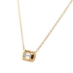 Your new signature piece is here! This gorgeous 14kt yellow gold necklace features a stationary large emerald cut (our favorite cut) diamond, set in a sleek bezel. The pendant measures approximately ⅜" long and is attached to an adjustable cable chain that can be worn at 16", 17" and 18" total length. Diamond: 0.80ctw Designer: Zoë Chicco, made in Los Angeles. Modern Gold Emerald Cut Necklace, Yellow Gold Necklace With Emerald Cut Bezel Setting, Yellow Gold Emerald-cut Necklace With Bezel Setting, Yellow Gold Emerald Cut Necklace With Bezel Setting, Gold Solitaire Necklace With Emerald-cut Diamond Accents, Gold Solitaire Necklace With Emerald Cut Diamond Accents, Timeless Gold Solitaire Necklace With Emerald Cut, Gold Necklace With Single Baguette Cut Diamond, Gold Baguette Cut Single Diamond Necklace