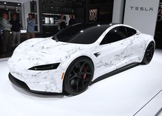 a white and black sports car is on display