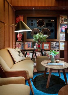 a living room filled with lots of furniture and bookshelves next to a window