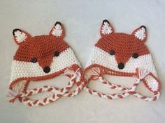 two crocheted hats made to look like foxes