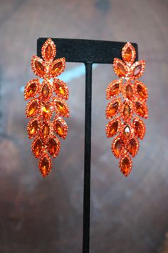 Orange Diamond Earrings, Red Bling Earrings For Party, Red Glamorous Chandelier Earrings For Party, Glamorous Red Chandelier Earrings For Party, Orange Dangle Earrings For Formal Occasions, Orange Pierced Earrings For Wedding, Party Chandelier Earrings With Sparkling Stones, Elegant Orange Chandelier Earrings For Party, Orange Dangle Earrings For Party