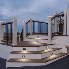 some lights are on the steps outside of a house