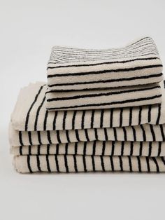 four black and white towels stacked on top of each other