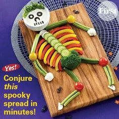 a wooden cutting board topped with vegetables on top of a table