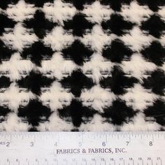 a ruler is next to a black and white checkered fabric