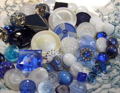 there are many different glass items on the table together in this photo, including blue and white