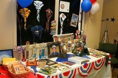 a table topped with pictures and balloons