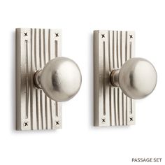 two silver door knobs on a white background