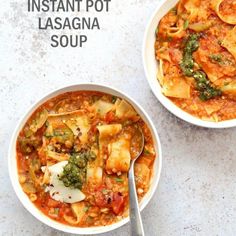 two bowls filled with pasta and vegetables on top of a white countertop next to a spoon