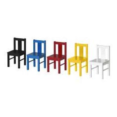 four different colored plastic chairs sitting next to each other