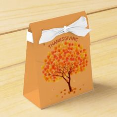 an orange thanksgiving gift bag with a tree on it