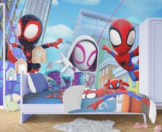 a child's bedroom with spiderman wallpaper