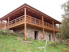 an old stone building with wooden balconies on the roof and balcony above it