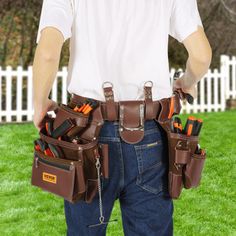 a man holding his tool belt full of tools