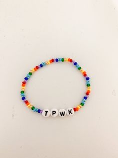 Handmade Harry Styles Treat People With Kindness Rainbow beaded bracelet. Show your hint of TPWK off to the world!  The bracelet also comes in other colors (listed), they are just not pictured! Harry Styles Bracelets, Kindness Rainbow, Rainbow Bead Bracelet, Bracelet Inspo, Rainbow Beads, Treat People With Kindness, Treat People, Colour List, May 20