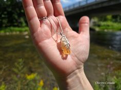 This handmade citrine pendant necklace exudes elegance, featuring a radiant natural citrine stone. Choose between a luxurious gold color chain or a sleek silver chain, allowing the warm golden hues of the citrine to shine with timeless sophistication, perfect for adding a touch of luxury to any outfit. Please be aware that each natural crystal is unique, with its own distinct characteristics. Minor imperfections, color variations, and natural fissures are common and contribute to the crystal's a Amber Citrine Crystal Necklace As Gift, Amber Citrine Crystal Necklace For Gift, Citrine Pendant Crystal Necklace With Natural Stones, Amber Citrine Crystal Necklace With Natural Stones, Citrine Pendant Necklace With Natural Stones, Citrine Pendant Necklace For Healing, Citrine Healing Pendant Necklace, Healing Amber Citrine Crystal Necklaces, Amber Citrine Pendant Crystal Necklace