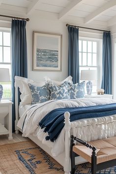 a bedroom with blue and white decor in it