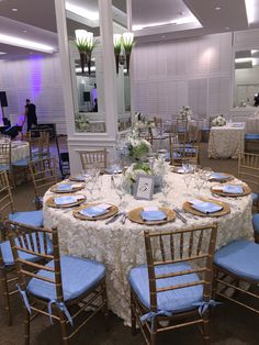 a table set up with blue and white linens