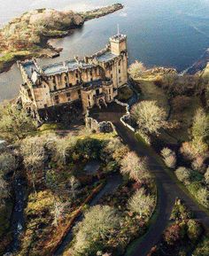 an aerial view of a castle near the water