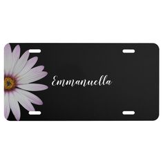 a black license plate with a pink daisy