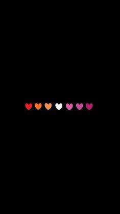 hearts are lined up in different colors on a black background