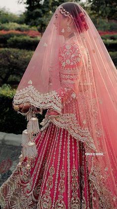 a woman in a red and gold bridal gown