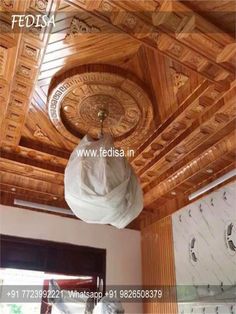 the inside of a room with wooden walls and ceilinging, including a round light fixture