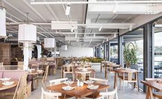 an empty restaurant with wooden tables and chairs