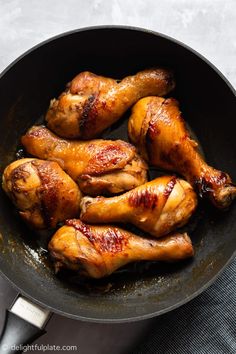 chicken wings cooking in a frying pan