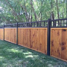 a wooden fence with black iron railings