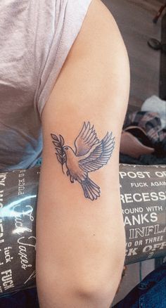 a person with a bird tattoo on their arm