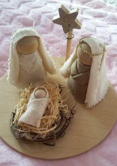 a nativity scene with baby jesus in the mangeracle and two small dolls