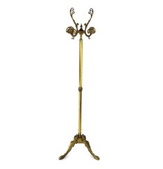 an antique brass floor lamp with three lights