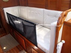 the back end of a boat with a black net on it's seat area