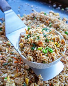 a bowl filled with rice sitting on top of a table