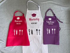 three aprons that have different designs on them