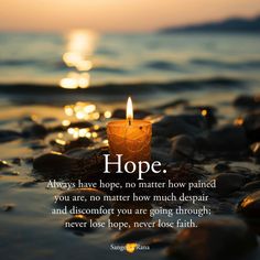 a candle that is sitting on some rocks in the water with a quote about hope