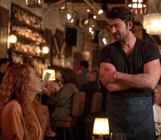 a man standing next to a woman in a restaurant