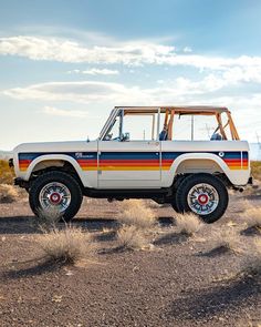 an old jeep is parked in the desert