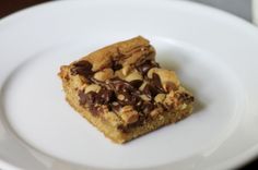 two pieces of chocolate chip cookie on a white plate