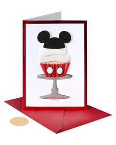 a mickey mouse cupcake on a red card